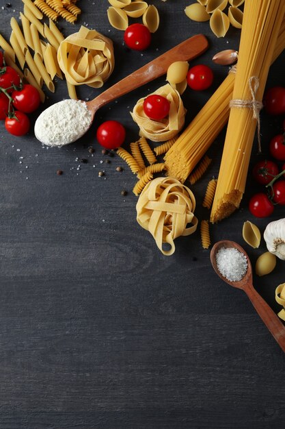 cooking tasty pasta on dark wooden surface