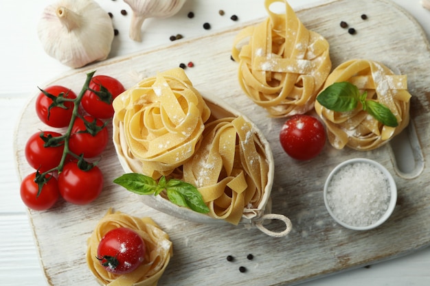 cooking tasty pasta on white wooden table