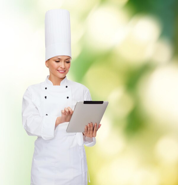 cooking, technology and food concept - smiling female chef with tablet pc computer