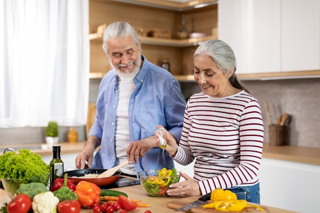 Cooking Together Happy senior spouses preparing lunch in kitchen