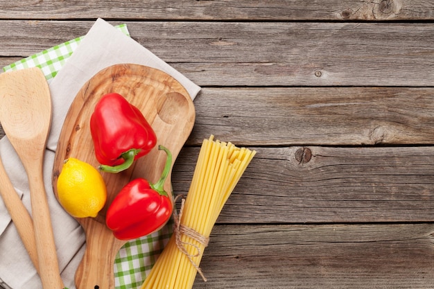 Cooking utensils and ingredients on wooden table