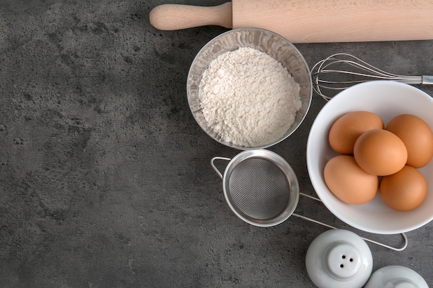 Cooking utensils and products on grey background