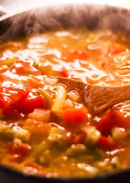 Cooking vegetable soup in saucepan comfort food and homemade meal