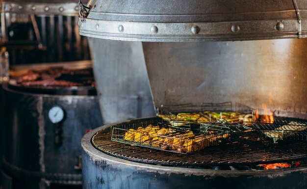 レストランのキッチンのグリルで野菜を調理する