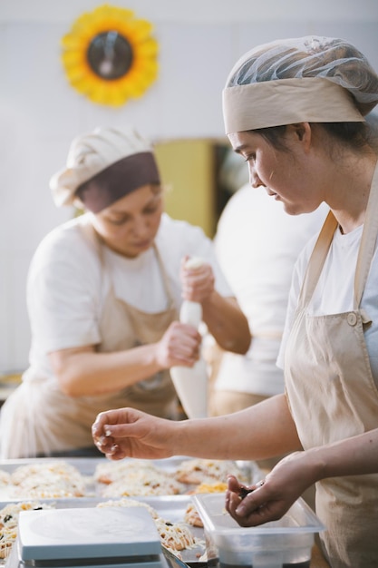 Cooks cook pizza in the bakery closeup