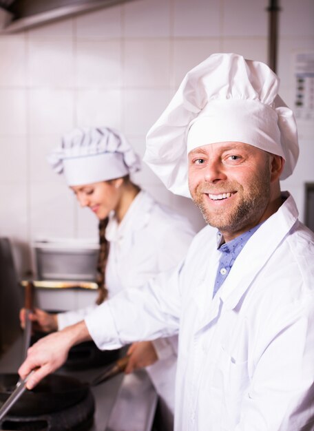 Cooks greeting customers at bistro