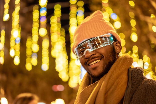 Cool african man wearing smart glasses outdoors at night