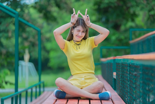 Cool Asian hipsters girl wear yellow dress posing for take a photolifestyle of modern womanThai people in hippie styleChill day for relax