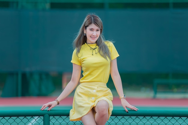 Cool Asian hipsters girl wear yellow dress posing for take a photolifestyle of modern womanThai people in hippie styleChill day for relax