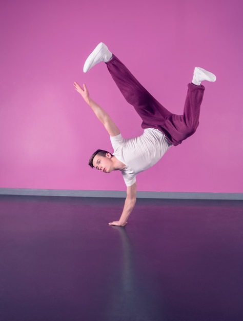 Cool break dancer doing handstand on one hand