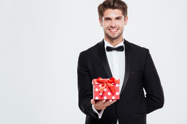 Cool businessman with gift. looking at front