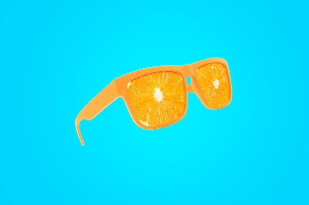 Cool fashion orange vitamins sunglasses with orange hovering on a blue background Juicy raw summer concept Creative idea for healthy eating