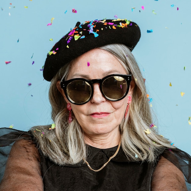 Cool grandma with an attitude in a beret and sunglasses