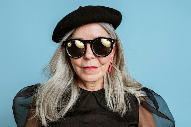 Cool grandma with an attitude in a beret and sunglasses