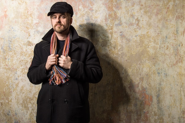 Cool guy rocks coat and newsboy cap