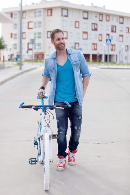 Cool guy with a vintage bicycle in the city