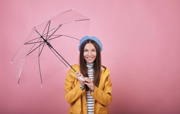 Cool laughing woman with opened umbrella in hand