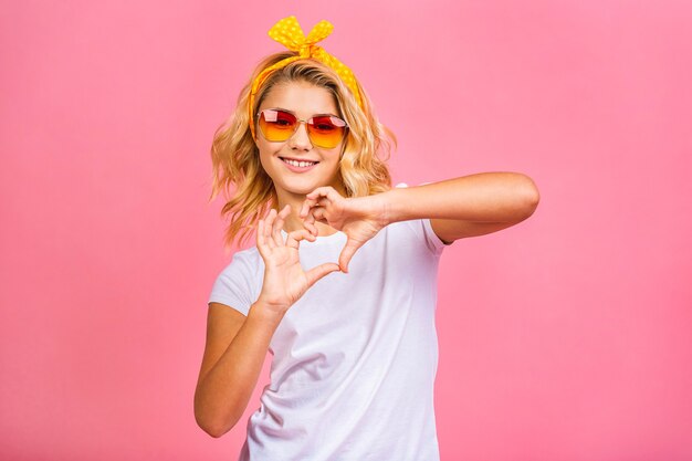 Cool little blonde girl. Charming teenage kid girl in fancy sunglasses