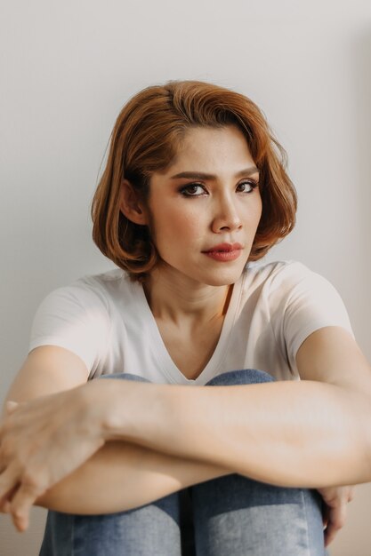 Cool looks woman in white tshirt and jean relax in her apartment room