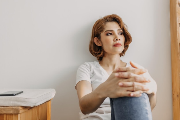 Cool looks woman in white tshirt and jean relax in her apartment room