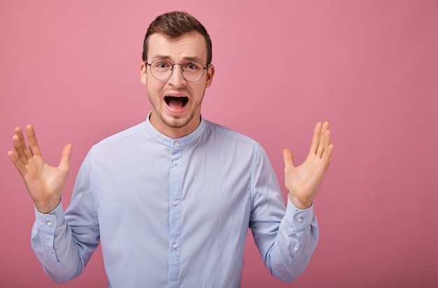 A cool man in blue shirt and computer glasses screams