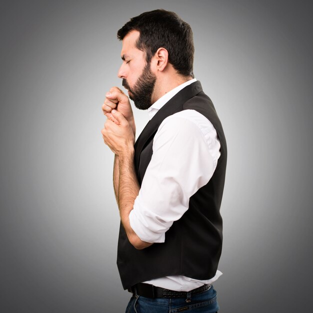 Cool man coughing a lot on grey background