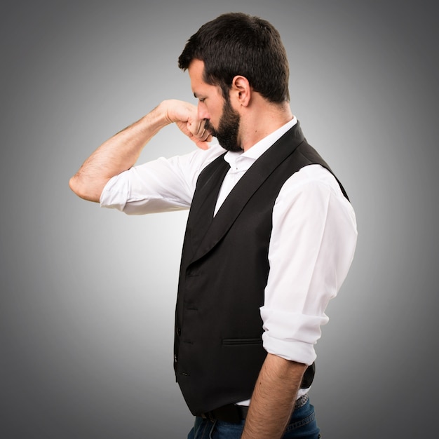 Cool man making strong gesture on grey background