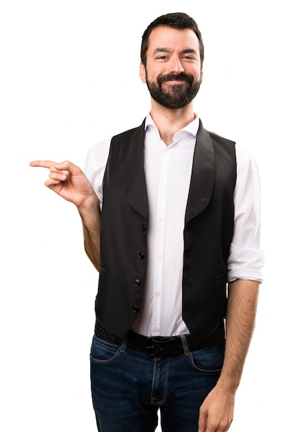 Cool man pointing to the lateral on isolated white background