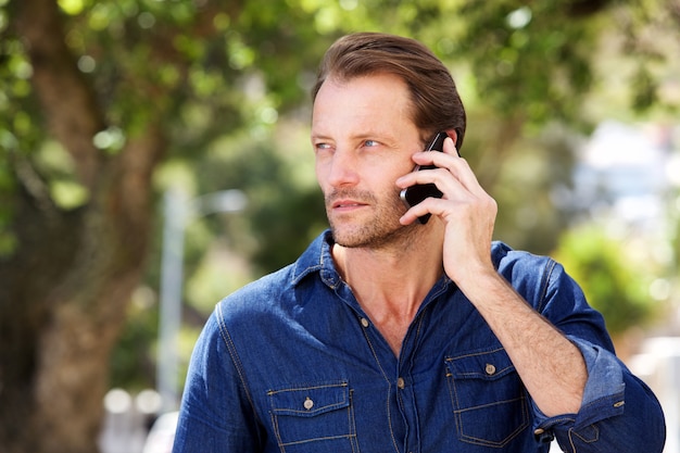 Cool older man talking on mobile phone 