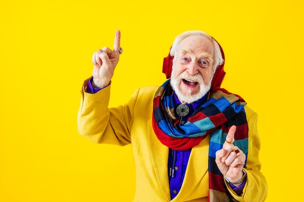 Cool senior man with fashionable clothing style portrait on colored background