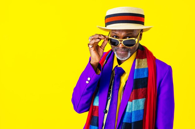 Cool senior man with fashionable clothing style portrait on colored background