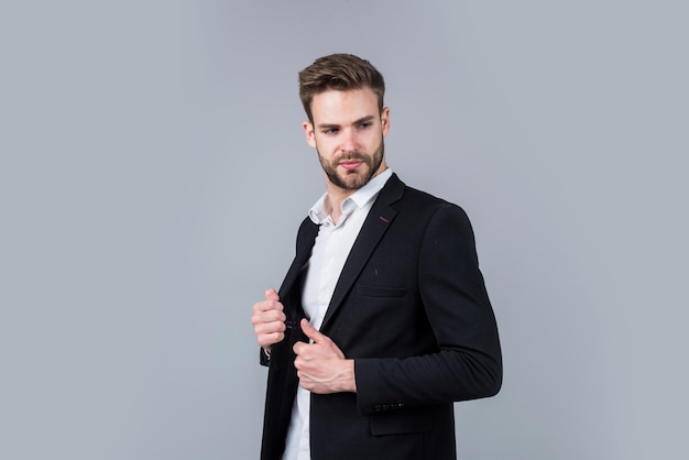 Cool and sexy modern office life charismatic business owner stylish realtor handsome man wear formal suit confident businessman in shirt and jacket boss male sexy ceo on gray background