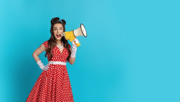 Cool shopping offer excited young pinup woman in retro style clothes shouting into megaphone making