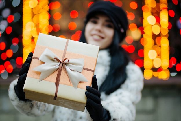 Cool young model pulls a gift box to you