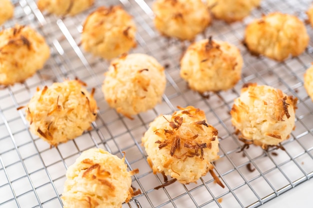 Cooling freshly baked coconut cookies on the kitchen drying rack.