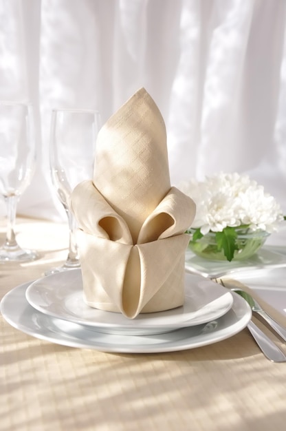 Coordinated decorative napkin on a plate with cutlery