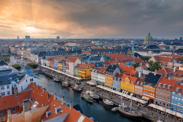 Copenhagen, Denmark. August 10, 2021. Aerial view of famous Nyhavn pier with colorful buildings and boats in Copenhagen, Denmark. The most popular place in Copenhagen.