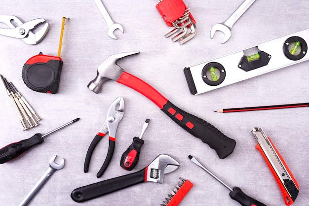 Coplet of repair tools on a gray  wall. Equipment for construction. Repair tool kit. View from above