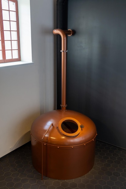 Copper brewing tank with wort in old brewhouse