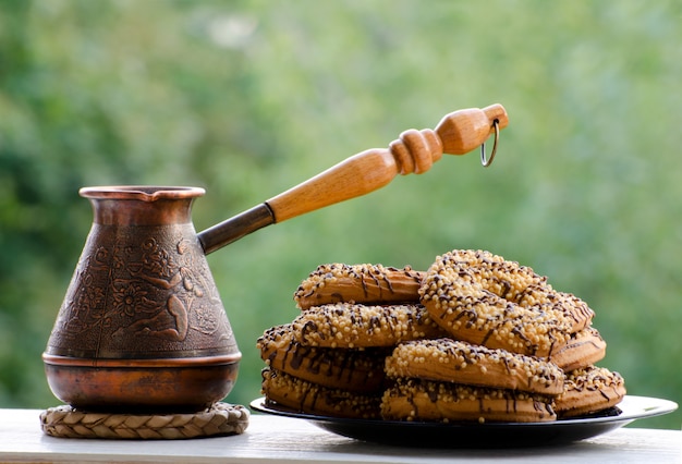 Copper Cezve of coffee and plate of cookies