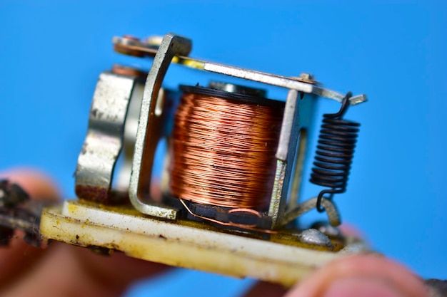 Photo copper coil switch in the hands of a master