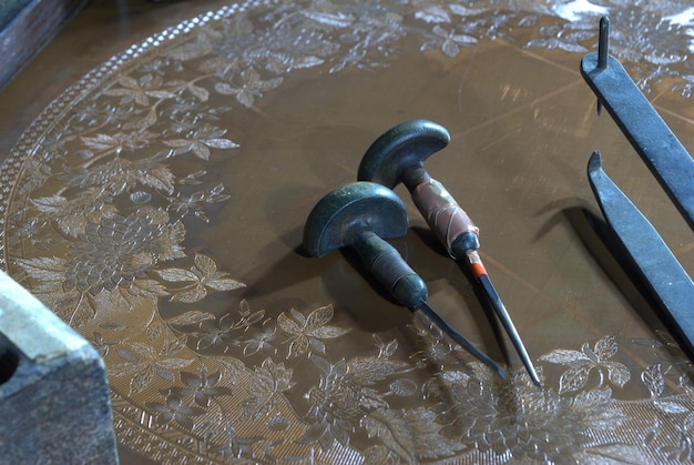 a copper plate and engraving tools, engraved for use in a printing process