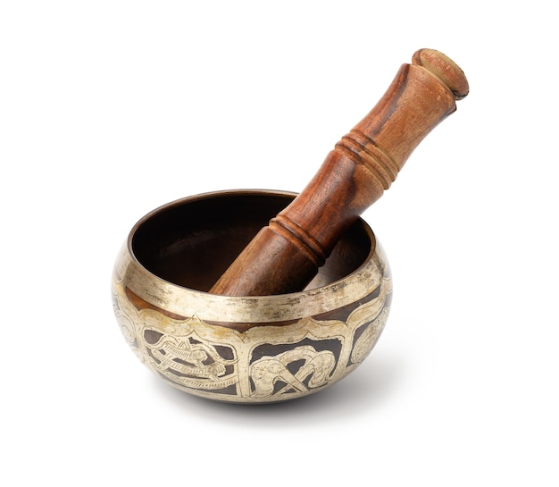 Copper singing bowl and wooden mallet isolated on white surface