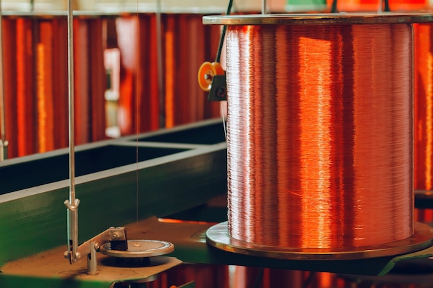 Copper wire reels in cable factory close up photo