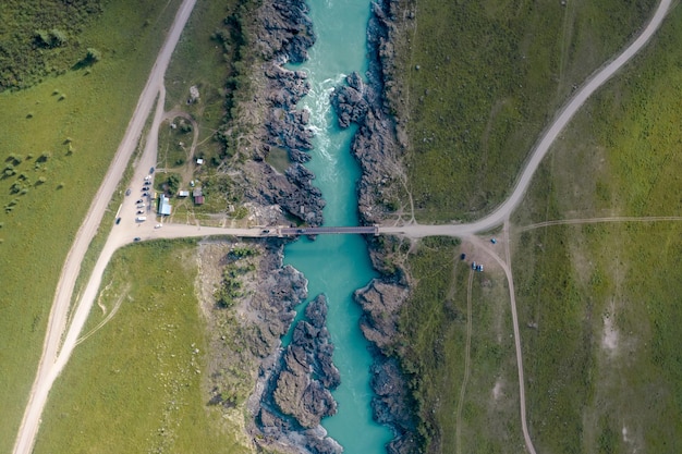 Copter's foto met een volwassen man kijkt naar een prachtig berglandschap dat op de rotsachtige stenen staat.