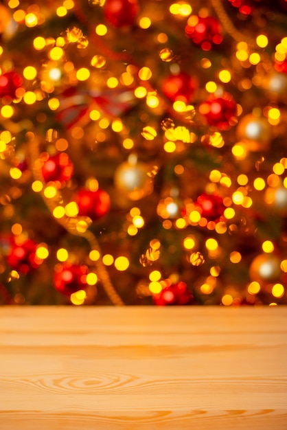 Copy space Christmas background Focus on wooden table bright lights of Christmas tree on the background