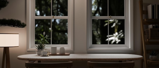 Copy space on a dining table by the window in a cozy minimalist room in the evening