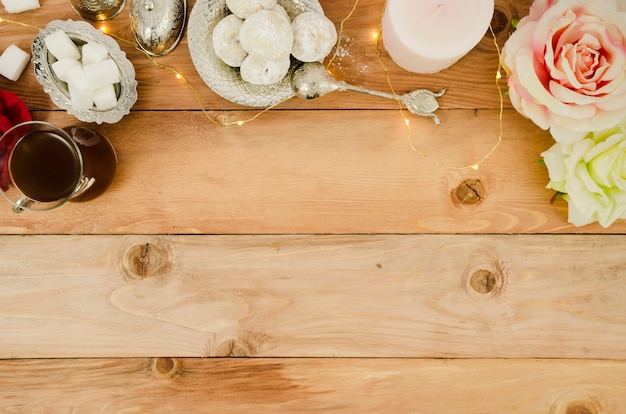 Copy space frame with roses and pastries