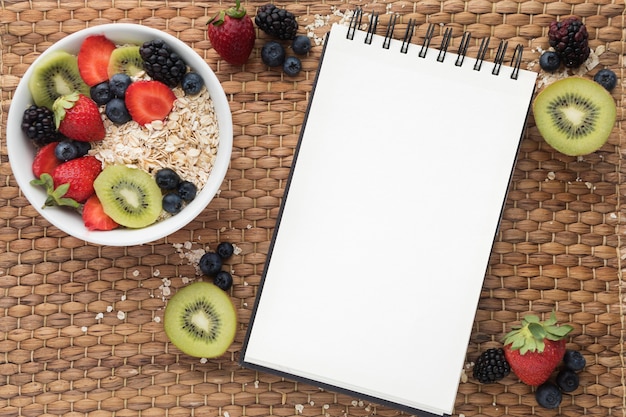 Copy space notepad and cereals with fruit