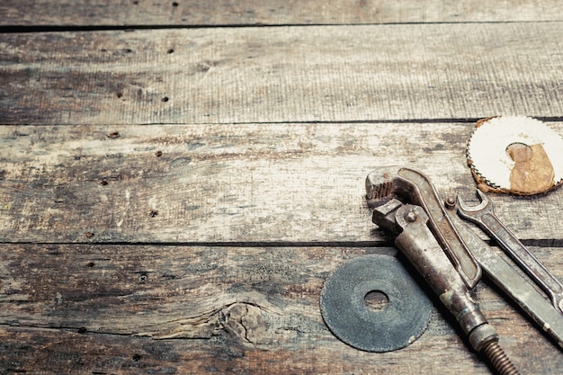 Photo copy space on old wooden background with vintage rusty tools